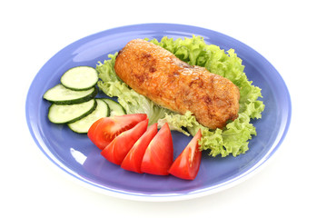 Tasty meat cutlet with garnish on plate isolated on white