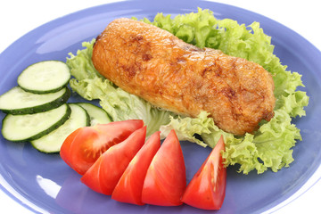 Tasty meat cutlet with garnish on plate close-up