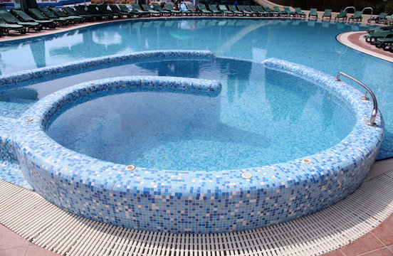 Curved blue tiled hotel resort swimming pool