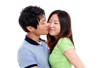 Happy couple hugging and kissing over white background