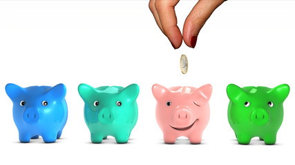 Woman's hand choosing a piggy bank and giving it a coin