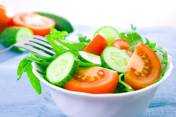 Fresh salad with tomatoes, rucola and cucumbers