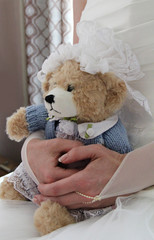 Bride with toy bear in wedding day