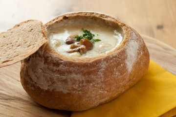 Cream of forest mushroom soup in a hollow rye bread