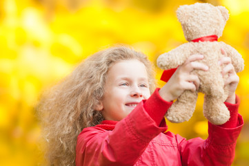 Beautiful little girl with teddy bear.