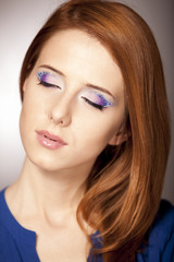 Naklejka premium Portrait of beautiful redhead girl with style make-up.