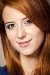 Portrait of beautiful redhead girl with style make-up.