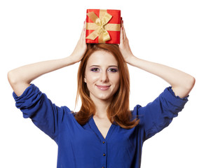 Beautiful red-haired girl with present box.