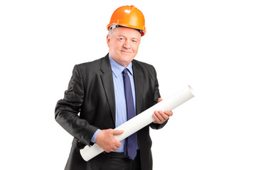 A mature engineer holding blueprints