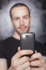 Man make photo with smartphone, focus on phone