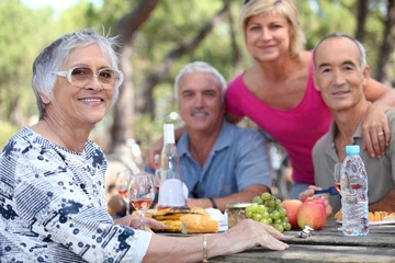Foto op Plexiglas Senior woman having a picnic with friends © auremar