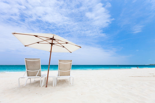 Two chairs under umbrella