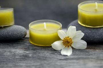 Fototapeta na wymiar Spa and healthcare concept- candle with white flower