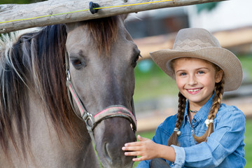 Lovely cowgirl and horse on a ranch