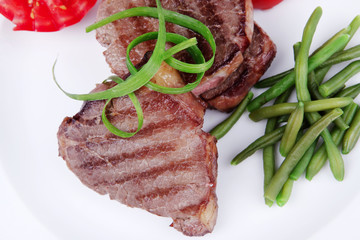 beef steaks strips on white plate
