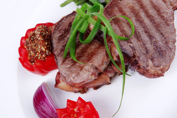 beef steaks strips on white plate
