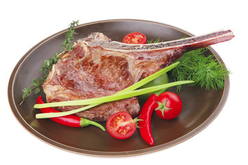 savory : grilled spare rib on dark dish with pepper and tomato