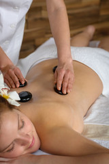 Lava stone massage woman at luxury spa
