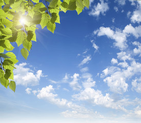 Blue sky with clouds and sun.