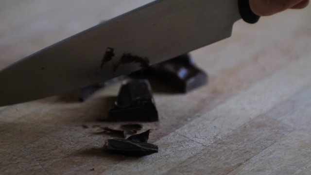 Hand of a woman chopping chocolate