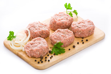 Meat balls arranged on a cutting board, isolated on white backgr