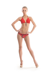 A young Caucasian woman posing in a red swimsuit