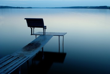 dock on the lake shore in the evening
