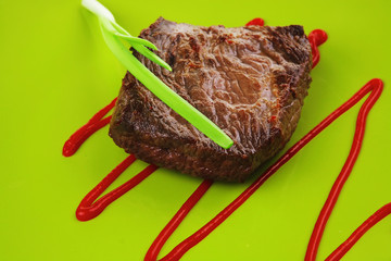 meat food : roasted fillet mignon on green plate with chives