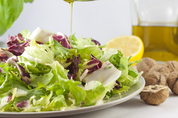 vegetables salad and pouring oil