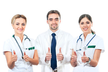 A team of three young Caucasian doctors in white clothes