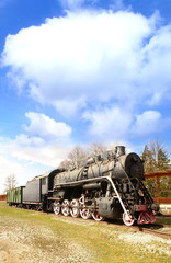An old and vintage train on a beautiful sky background