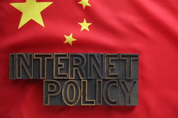 the words internet policy on a Chinese flag