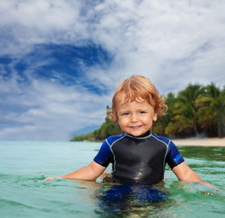 Happy toddler in wet suit