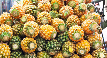 pineapples at a market stall.