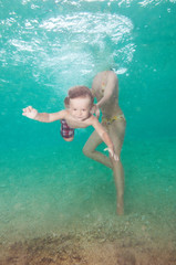 Mother teach little son to swim