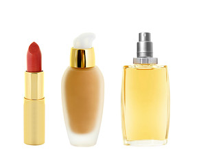 red lipstick in golden tube, makeup foundation and perfume isola