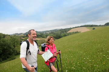 Senior couple hiking in natural landscape