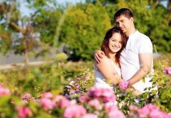 Men and woman in rose garden
