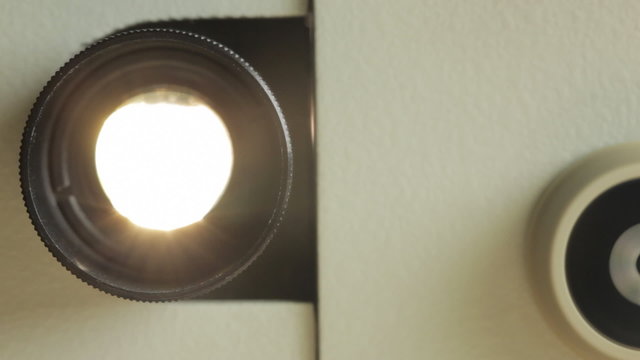 Front view of 8mm film projector lens in action.