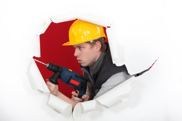 Tradesman demolishing a wall