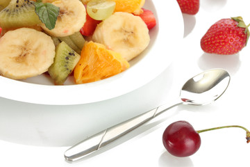 Fresh fruits salad on plate and berries isolated on white