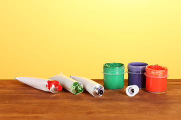 Tubes with colorful watercolors and jars with gouache