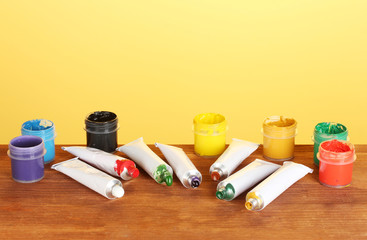 Tubes with colorful watercolors and jars with gouache