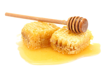 golden honeycombs and wooden drizzler with honey isolated