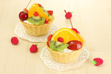 sweet cake with fruits on wooden table