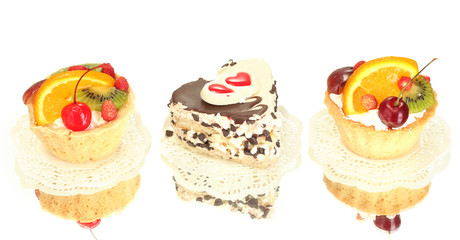 sweet cakes with fruits and chocolate isolated on white