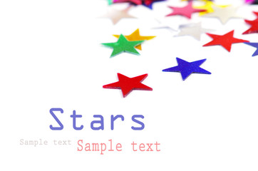 Christmas decoration of colored confetti stars against white bac