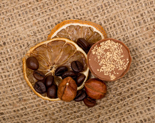 Sweet, lemon, nuts and coffee beans on burlap