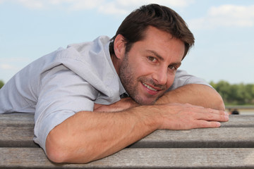 smiling man on a bench