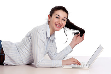 A beautiful woman working with a laptop on the floor